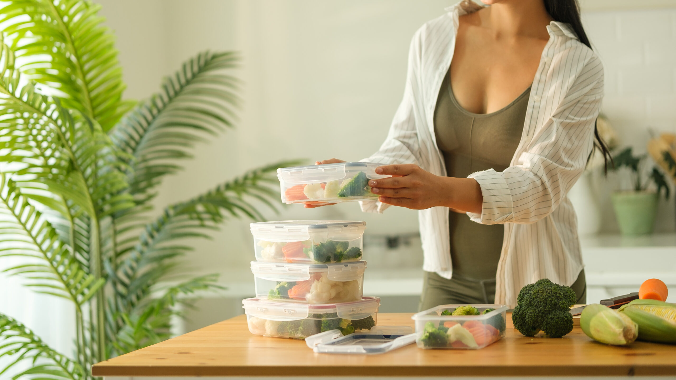 Attractive woman arranging her meal prep containers on the kitchen counter, ready for a week of healthy eating. Healthy lifestyle and nutrition concept. Attractive woman arranging her meal prep containers on the kitchen counter, ready for a week of healthy eating. Healthy lifestyle and nutrition concept.